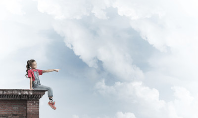 Concept of careless happy childhood with girl showing touch gest