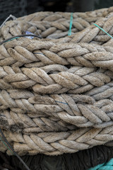 Fototapeta na wymiar Closeup view to stacked and knotted old rope