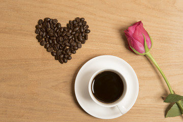 Coffee with coffee beans and a single rose 