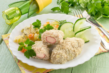 Fish cutlets stuffed with surimi and stewed potatoes with carrots