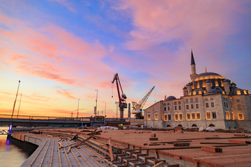 Fototapeta na wymiar Silhouette view of dock crane and modern look mosque near the Marmara