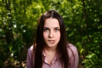 Fototapeta premium Portrait of attractive young indecisive shy woman face close up