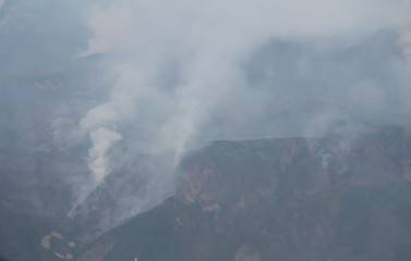 Smoke from a fire in the mountains, top view