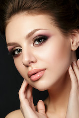 Portrait of young beautiful woman with evening make up