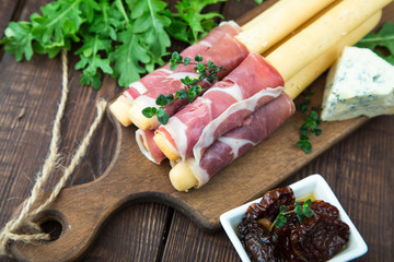 Appetizer with  prosciutto, ham, blue cheese and sun dried tomatoes for holidays