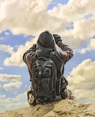 Man Taking Photos of Cloudy Sky