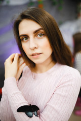 A large tropical butterfly sits on the hand of a girl's man. Concept man and nature are one.