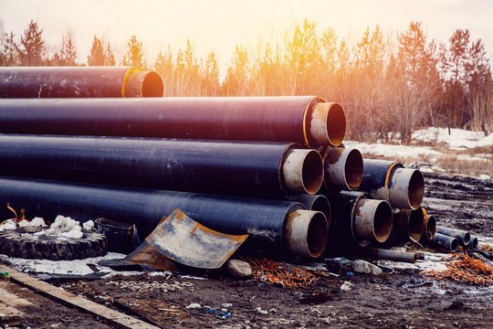 pile stack of big pipes on construction site. Concept of building a house and road, communications.