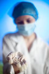 Obraz na płótnie Canvas Nurse with pills in hand in hospital