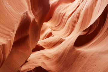 Nature red sandstone textured background. Swirls of old red  sandstone wall abstract pattern in Lower Antelope Canyon, Page, Arizona, USA.