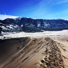 Sand dunes, mountains, and snow