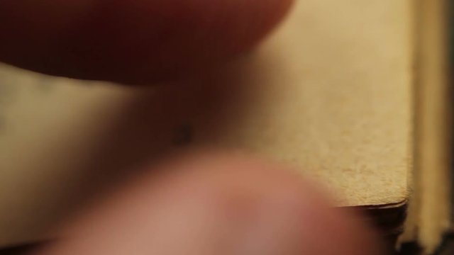 Close up of hands turning pages.