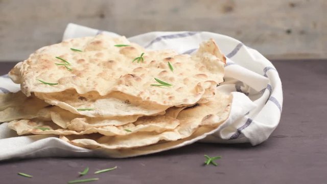 Homemade hot chapati on kitchen countertop background. Slide from left.