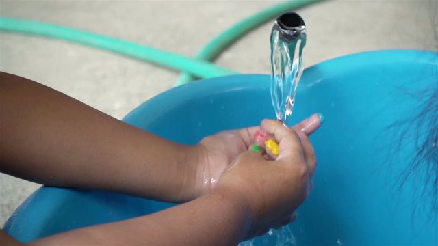 Close-up of asian children hand washing in slow motion.