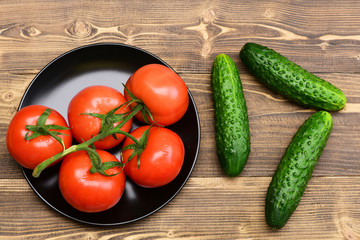 cucumbers with tomato on plate on brown vintage, vegetable concept