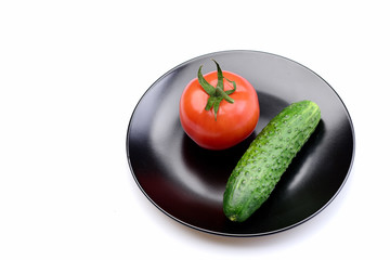 Tomato with cucumber on plate isolated on white, vegetable concept