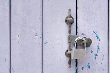 Metal padlock on wooden door, closeup. Nobody