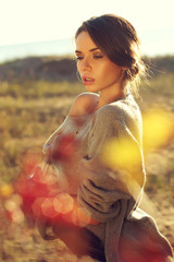 Obraz premium young pretty woman standing in autumn yellow colours field and dreaming with closed eyes. beautiful portraits made with backlit