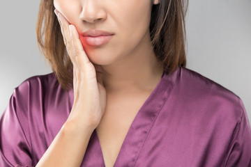 Closeup of beautiful young woman suffering from toothache, Dental health and care, People with teeth problem concept.