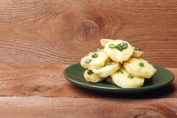 Appetizer of potatoes, cheese and green onions. There is room for text