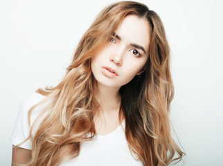 Young beautiful woman posing with white t-shirts, ower white background