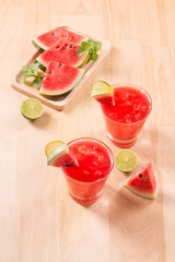 Watermelon drink in glasses with slices of watermelon in summertime