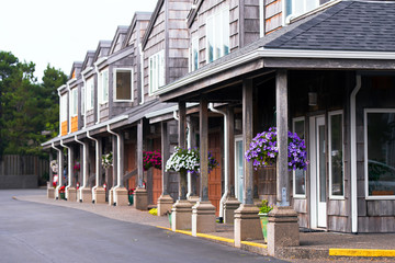 Fototapeta premium Flower baskets on the porticoes in the residential appartment complex