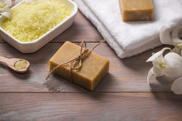 Obraz na płótnie Canvas Spa set. Handmade, natural organic soap and white orchid on a wooden background