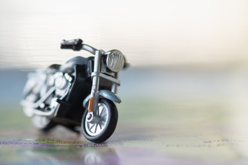 Travel Concept. Close up of motorcycle toy on map with copy space