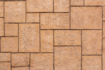 Brown brick wall of different sizes