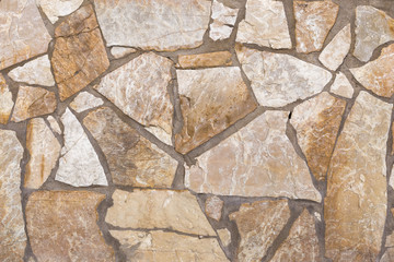 Wall of stones of brown and white colors