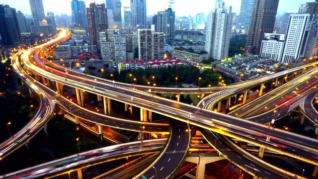 Aerial View freeway busy city rush hour heavy traffic jam highway,shanghai Overpass interchange,driving & cars racing by with streaking lights trail with super long exposures from day to night.