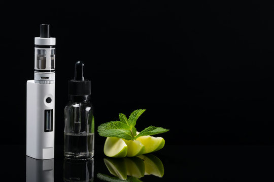 Mint apple taste for an electronic cigarette with reflection on a black background