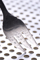 Fork on a table with abstract light reflection