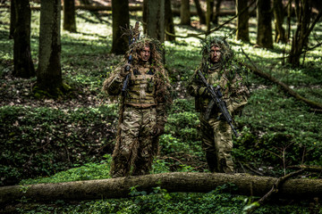 Obraz premium Camouflaged soldiers in forest