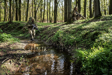 Camouflaged soldiers in forest © Piotr Jankowiak