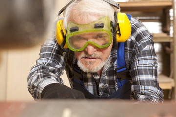 Carpenter working in furniture factory
