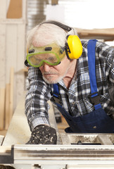 Carpenter working in furniture factory