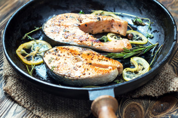 Salmon steak, fried with herbs, pepper and lemon