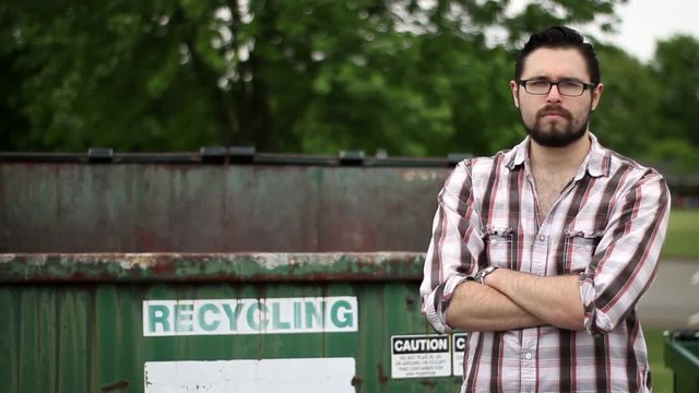 Handsome young garbage owner entrepreneur serious about recycling and saving the planet