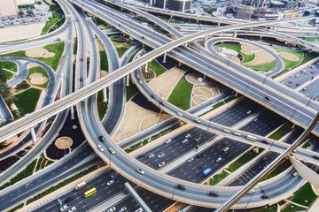 Scenic aerial view of big highway intersection in Dubai, UAE, at daytime. Transportation and...