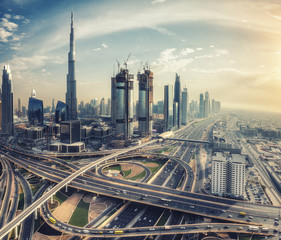 Obraz premium Spectacular skyline of Dubai, UAE. Futuristic modern architecture of a big city at sunset. Aerial view.