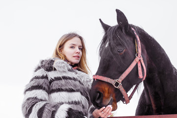 Fototapeta premium Nice girl and horse outdoor in a winter
