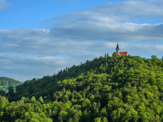 church on top of the hill. clouds and vlue sky