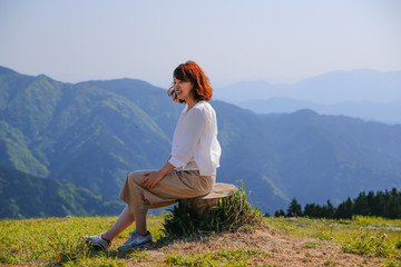 Japanese woman on green mountain