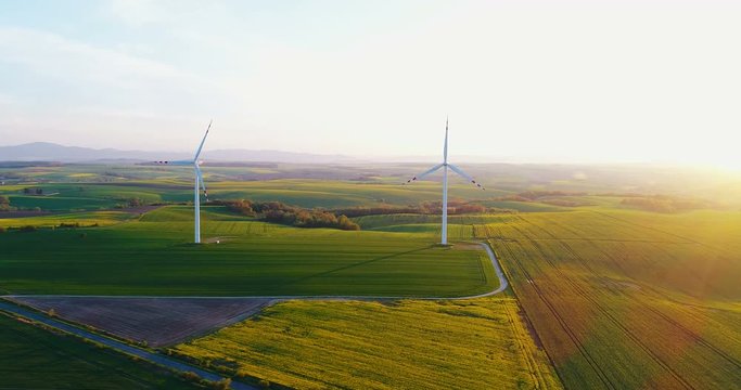 Beautiful view of windmill turbine at sunset. Renewal Energy.