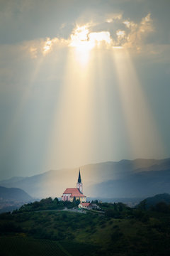 Sun Rays Shining Down On A Church