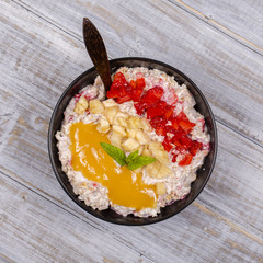 Muesli made from red strawberries, banana, chia seeds, oat flakes, honey and dressed with yogurt