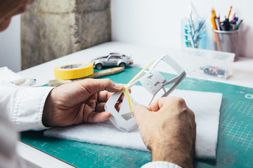 Person using tape for car paint