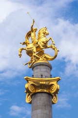 Fototapeta na wymiar Golden sculpture of Saint George on the Freedom Square in Tbilisi